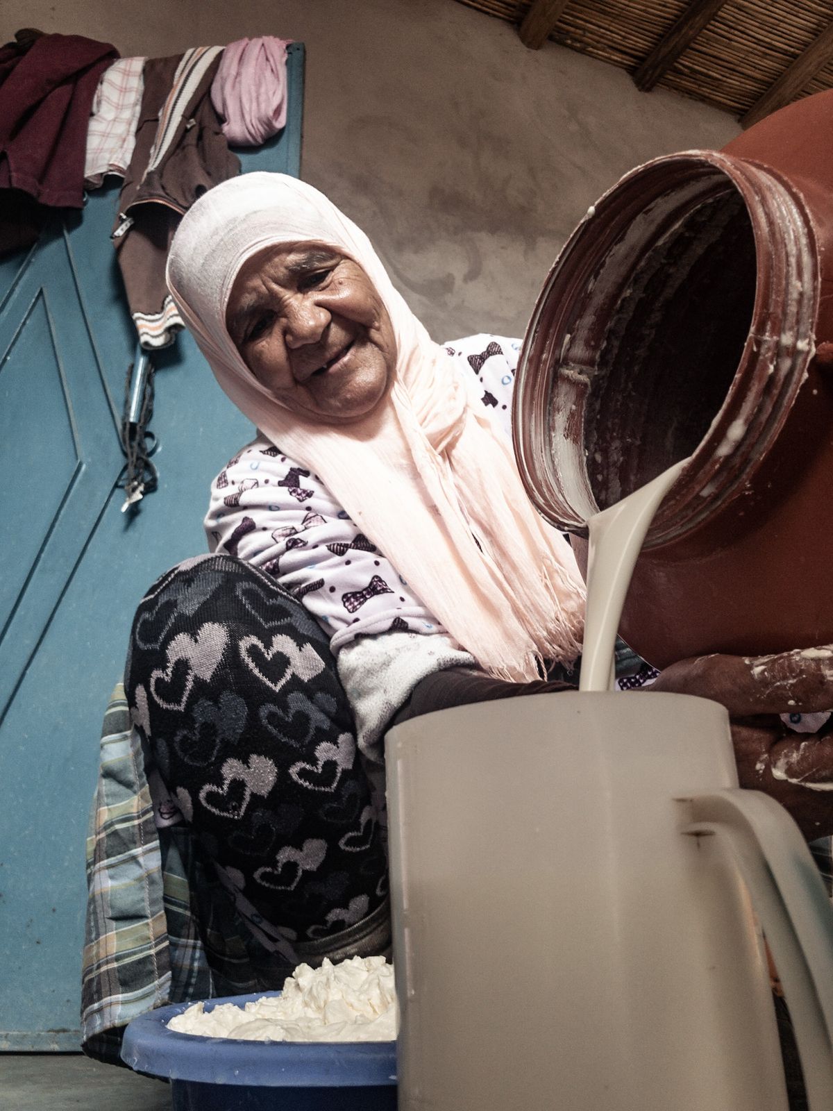 Femme versant du lait dans une cuisine